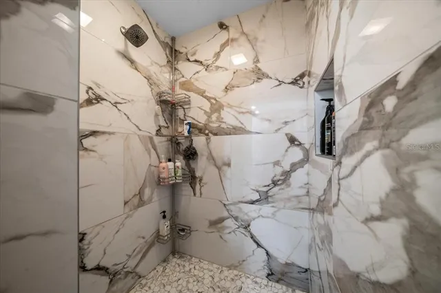 a bedroom with a bed dresser and window