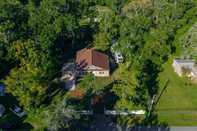 an aerial view of a house with a yard