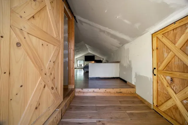 a view of kitchen with wooden floor and electronic appliances