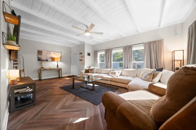 a living room with furniture and a large window