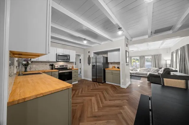 a kitchen with refrigerator and cabinets