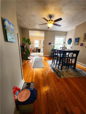 a view of a dining room with furniture and wooden floor