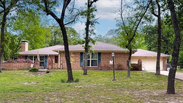 a house that has a tree in front of it