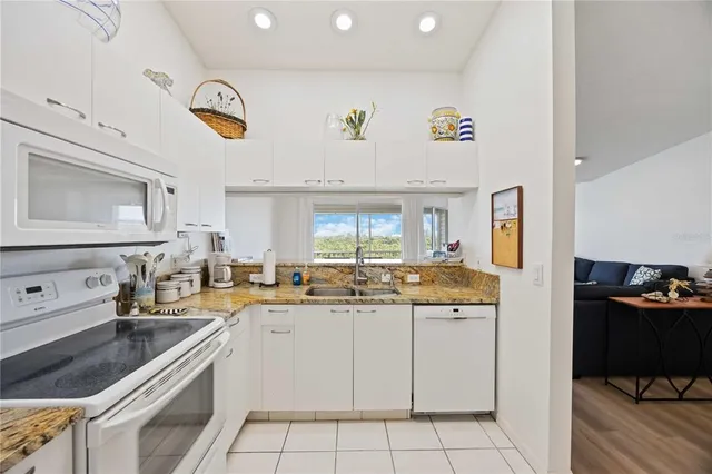 a kitchen with a sink window and cabinets