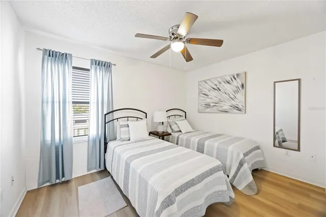 a bedroom with two beds and painting on the wall