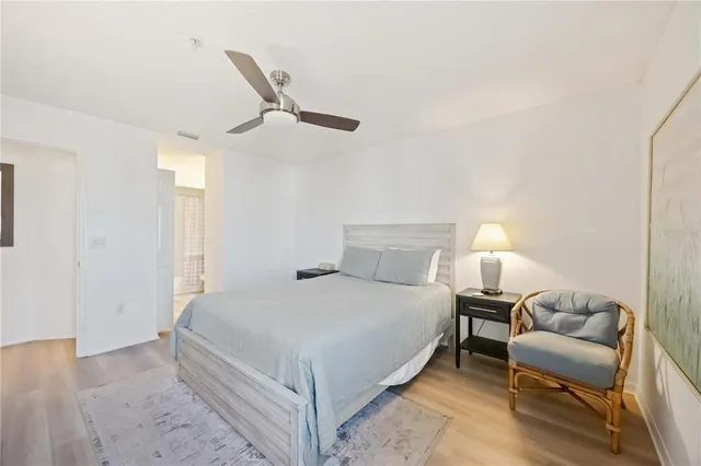 a bedroom with a bed couch and a night stand