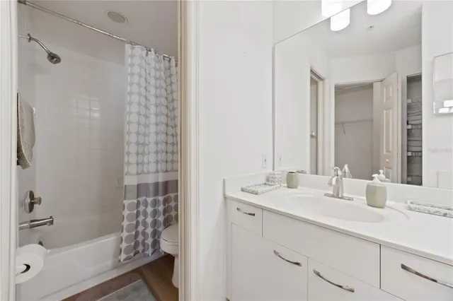 a bathroom with a sink double vanity mirror and shower