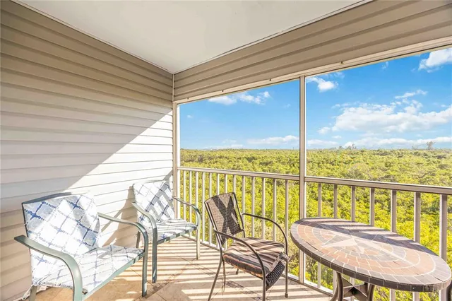 a view of a balcony dining area with furniture