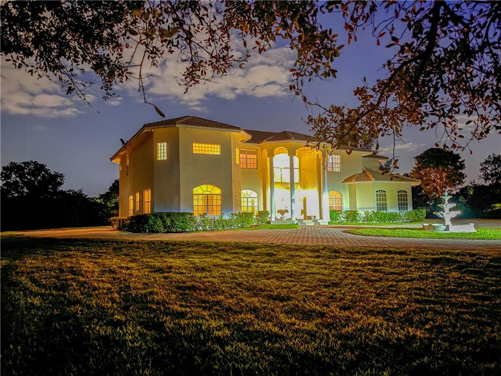 6150 Hancock Road Southwest Ranches, FL 33330 - Photo 1 of 41 a view of a brick house with a big yard and large trees