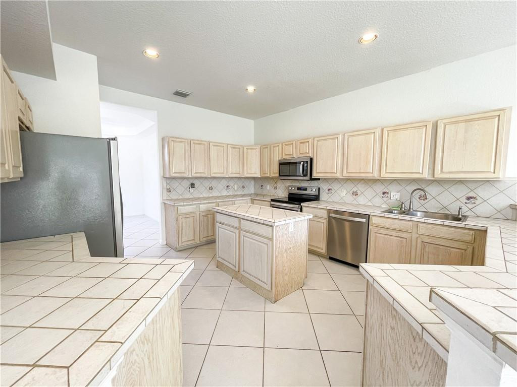 6150 Hancock Road Southwest Ranches, FL 33330 - Photo 14 of 41 a kitchen with a white stove top oven and white cabinets