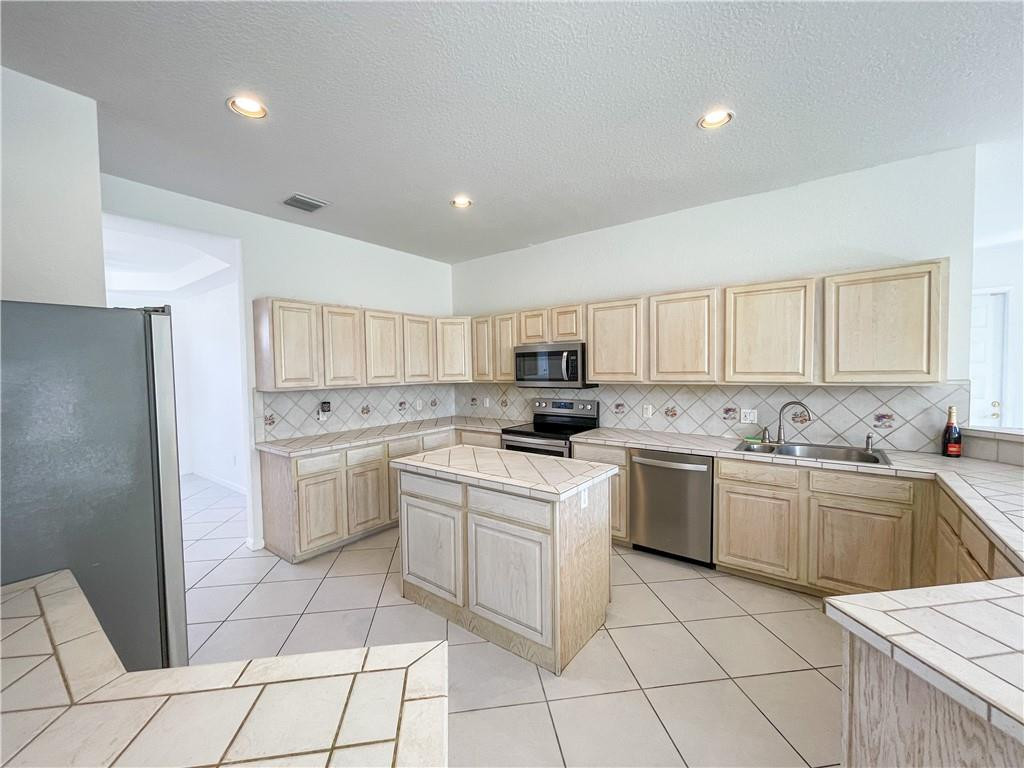 6150 Hancock Road Southwest Ranches, FL 33330 - Photo 15 of 41 a kitchen with white cabinets appliances and a sink