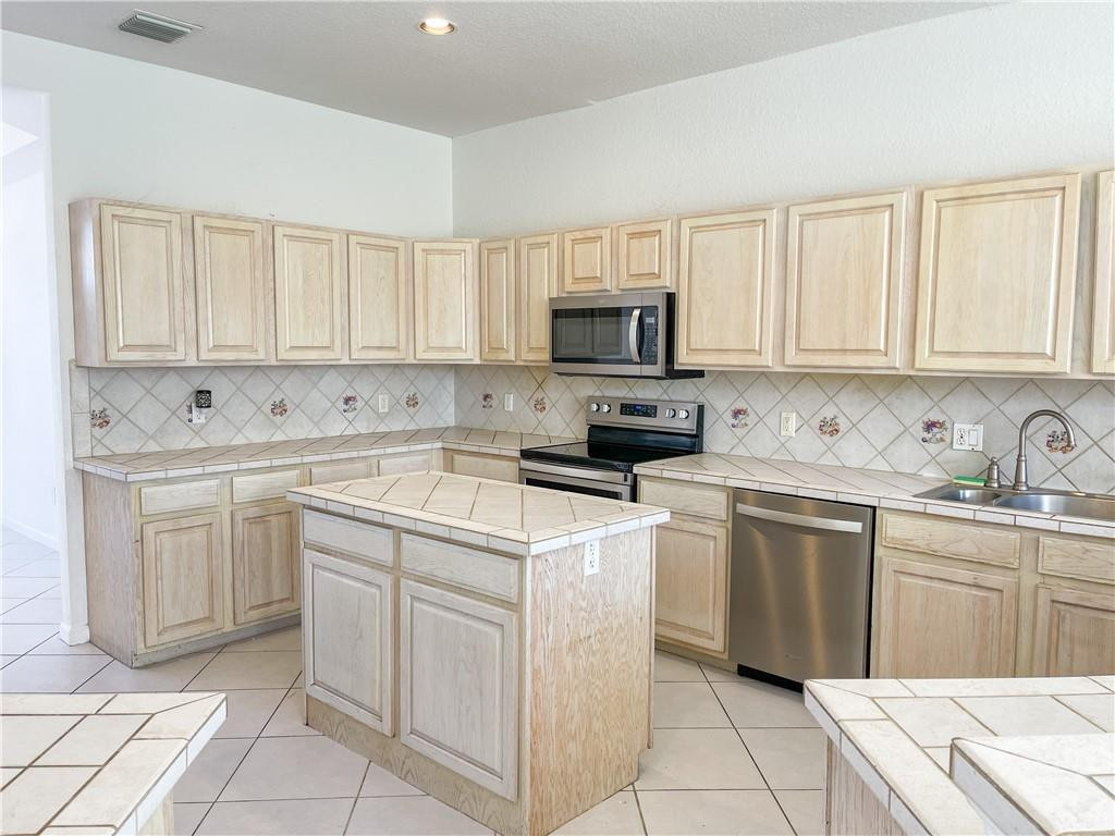6150 Hancock Road Southwest Ranches, FL 33330 - Photo 16 of 41 a kitchen with cabinets appliances a sink and a counter top space