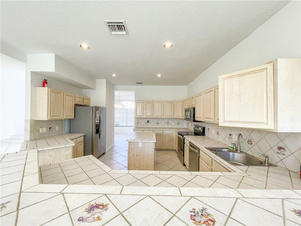6150 Hancock Road Southwest Ranches, FL 33330 - Photo 17 of 41 a kitchen with stainless steel appliances kitchen island granite countertop a sink and a stove top oven