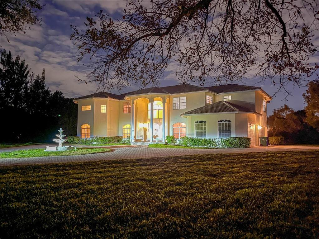 6150 Hancock Road Southwest Ranches, FL 33330 - Photo 3 of 41 a front view of a house with a yard