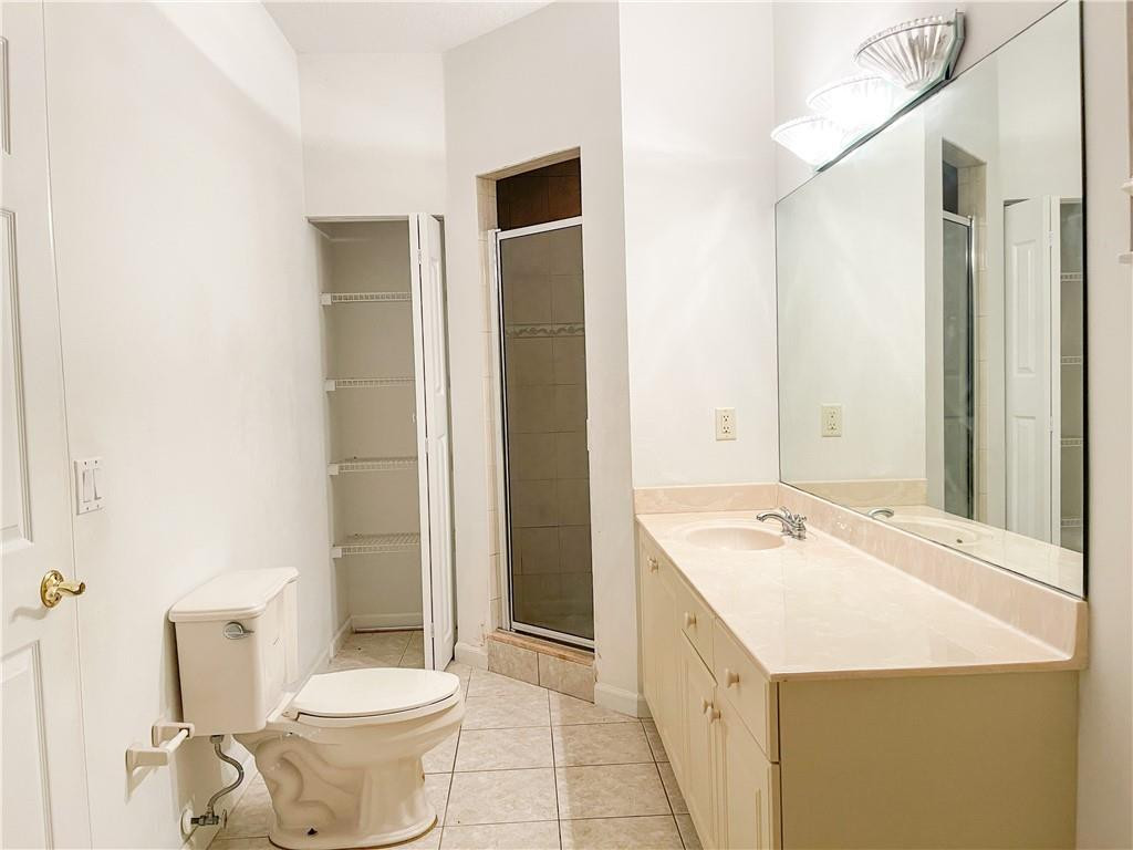 6150 Hancock Road Southwest Ranches, FL 33330 - Photo 33 of 41 a bathroom with a granite countertop sink a toilet a mirror and shower