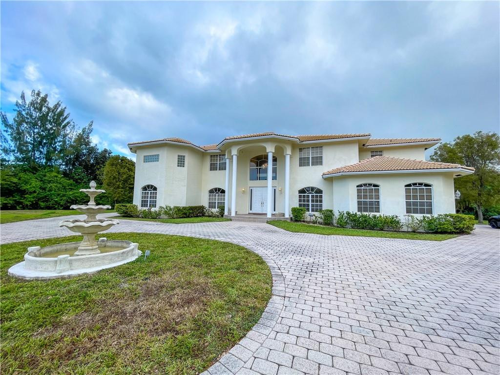 6150 Hancock Road Southwest Ranches, FL 33330 - Photo 40 of 41 a front view of a house with a yard and potted plants