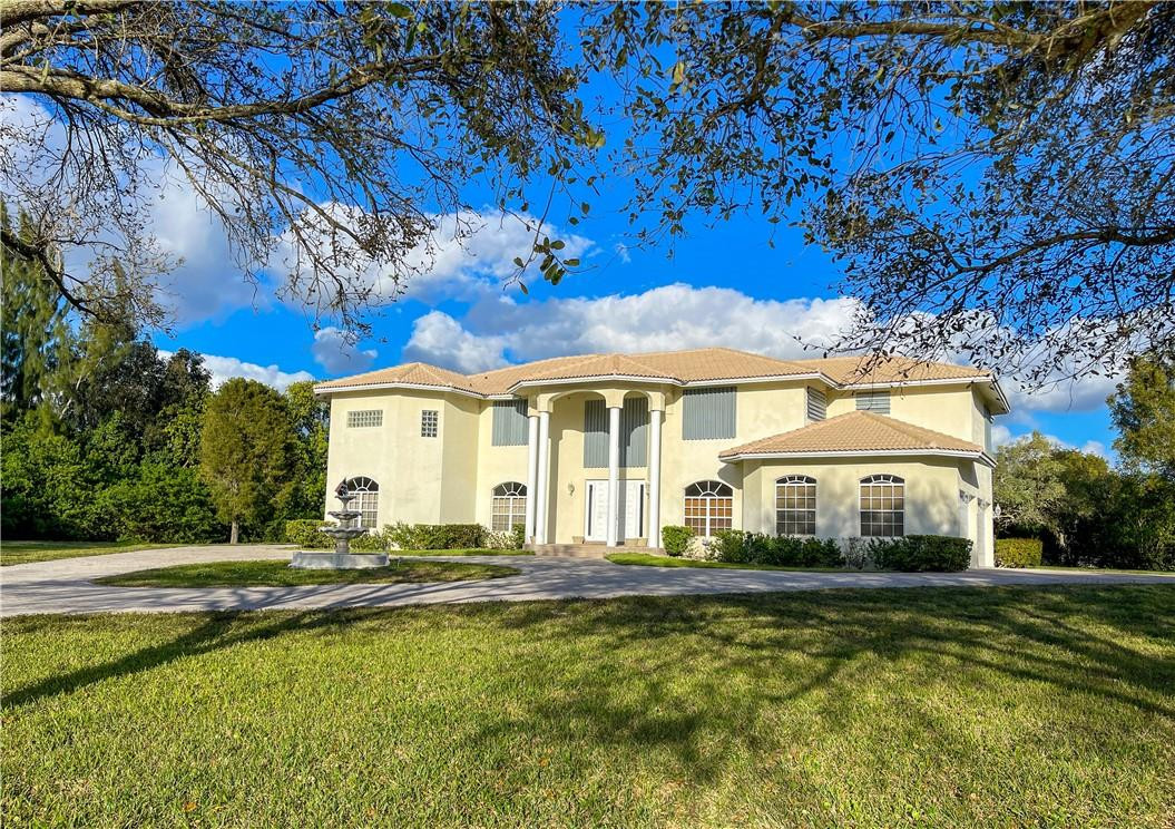 6150 Hancock Road Southwest Ranches, FL 33330 - Photo 4 of 41 a front view of a house with swimming pool