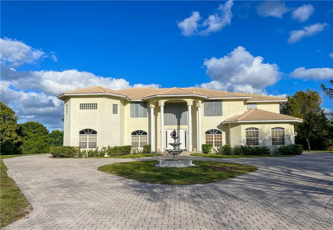 6150 Hancock Road Southwest Ranches, FL 33330 - Photo 6 of 41 a front view of a house with a yard