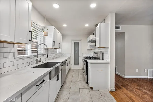 a kitchen with a sink stove and cabinets