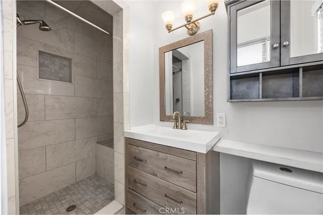 a bathroom with a sink a mirror and shower