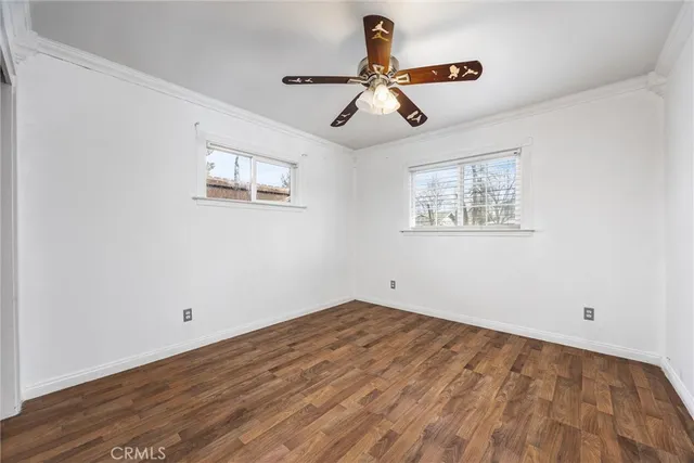 a view of empty room with wooden floor