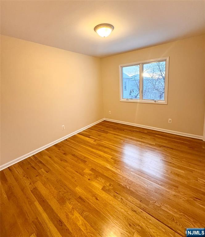 57 Franklin Street, Unit 2 Elmwood Park, NJ 07407 - Photo 12 of 19 an empty room with wooden floor and windows