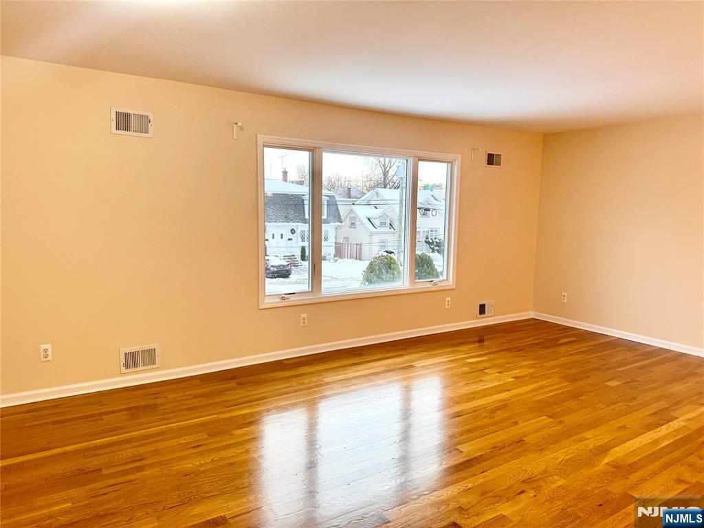 57 Franklin Street, Unit 2 Elmwood Park, NJ 07407 - Photo 5 of 19 a view of an empty room with wooden floor and a window