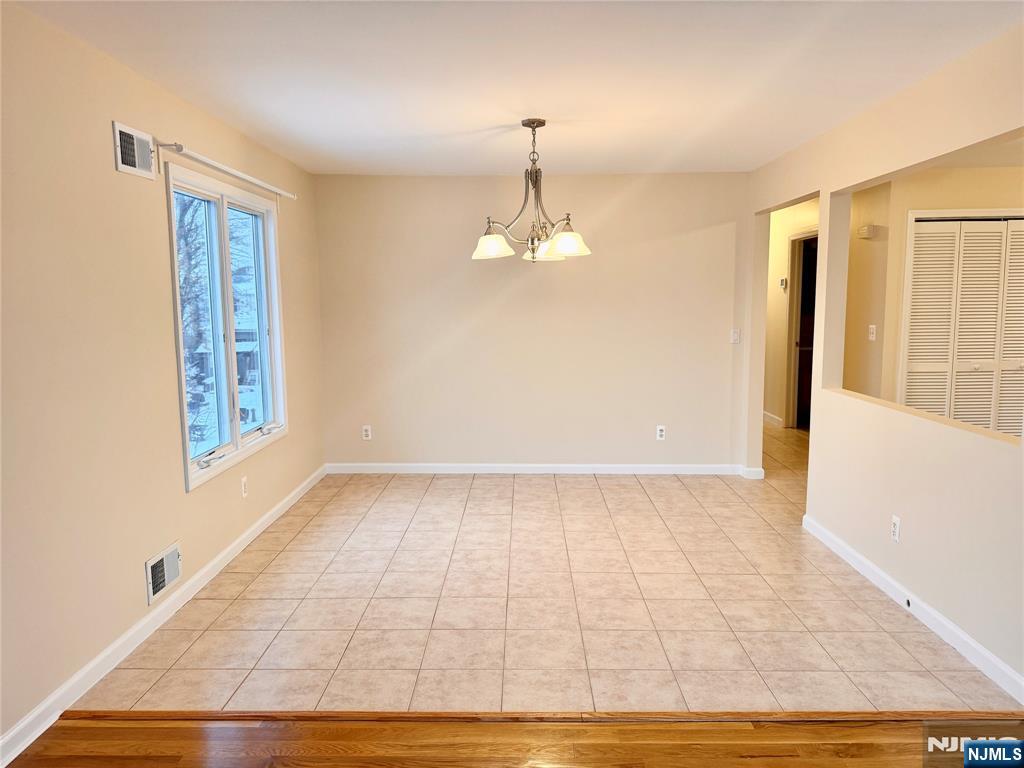 57 Franklin Street, Unit 2 Elmwood Park, NJ 07407 - Photo 10 of 19 a view of an empty room with wooden floor and a window