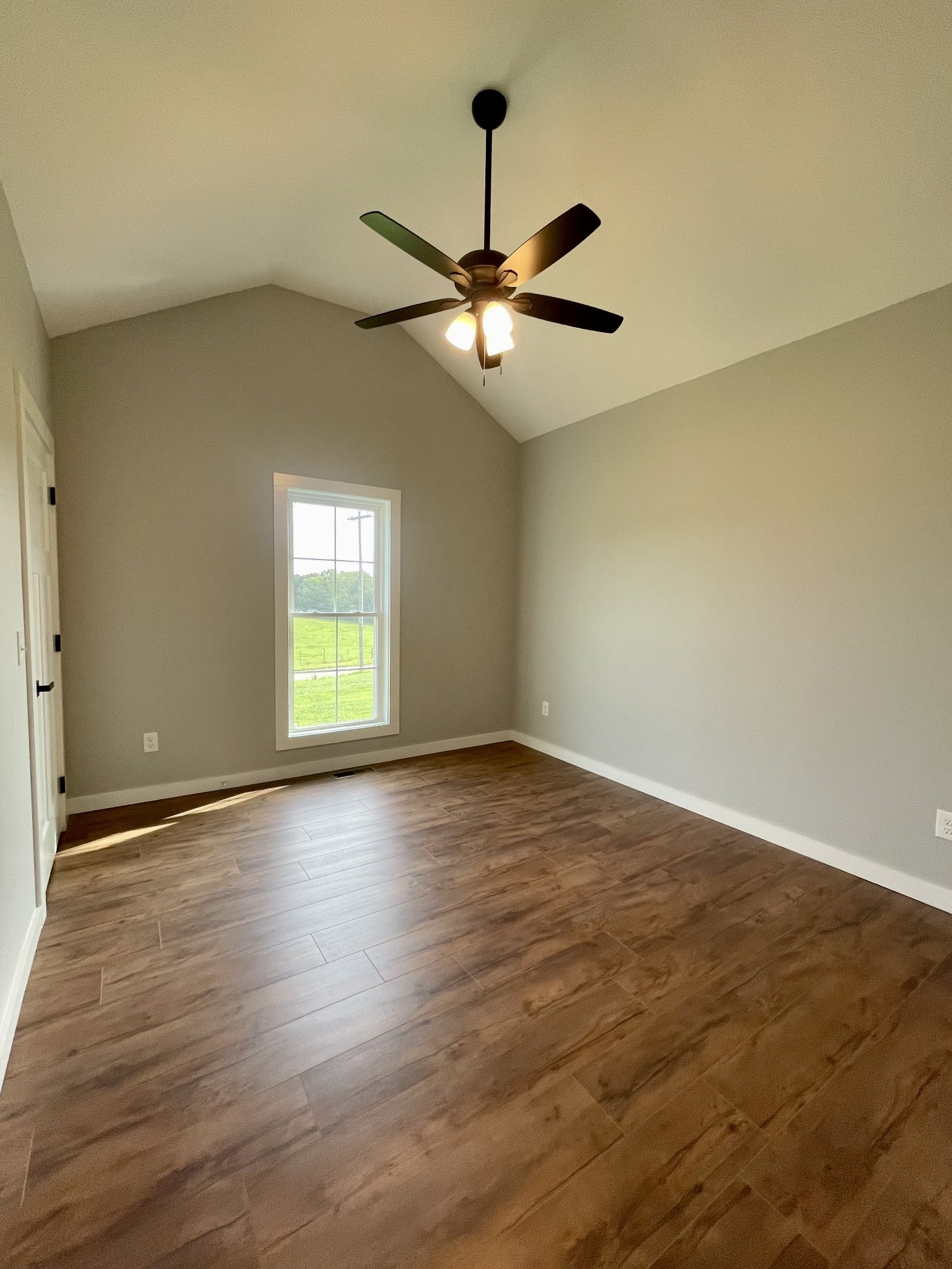 1448 Fall River Road Lawrenceburg, TN 38464 - Photo 14 of 30 a view of an empty room with window and wooden floor