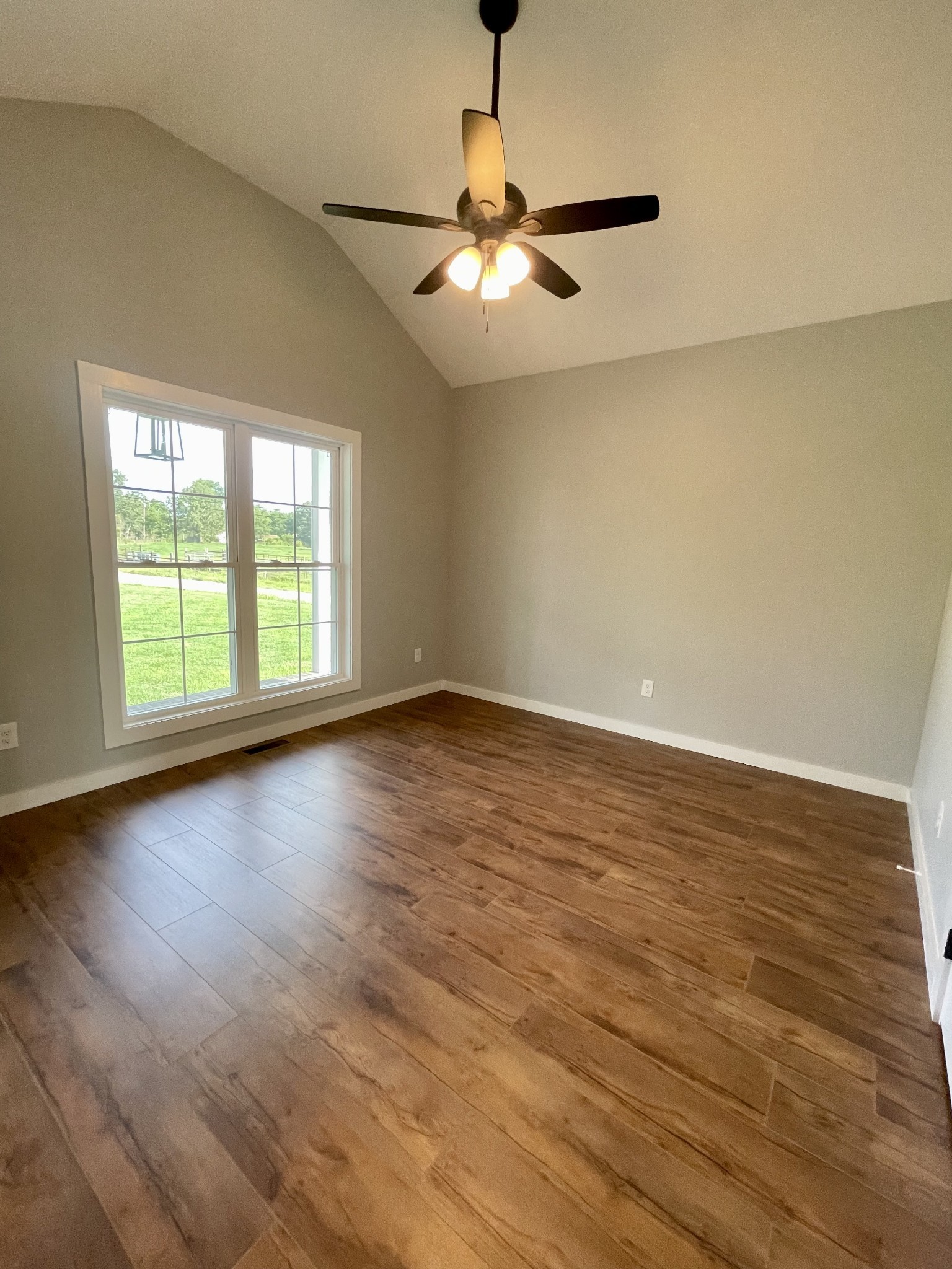 1448 Fall River Road Lawrenceburg, TN 38464 - Photo 16 of 30 a view of an empty room with wooden floor and a window