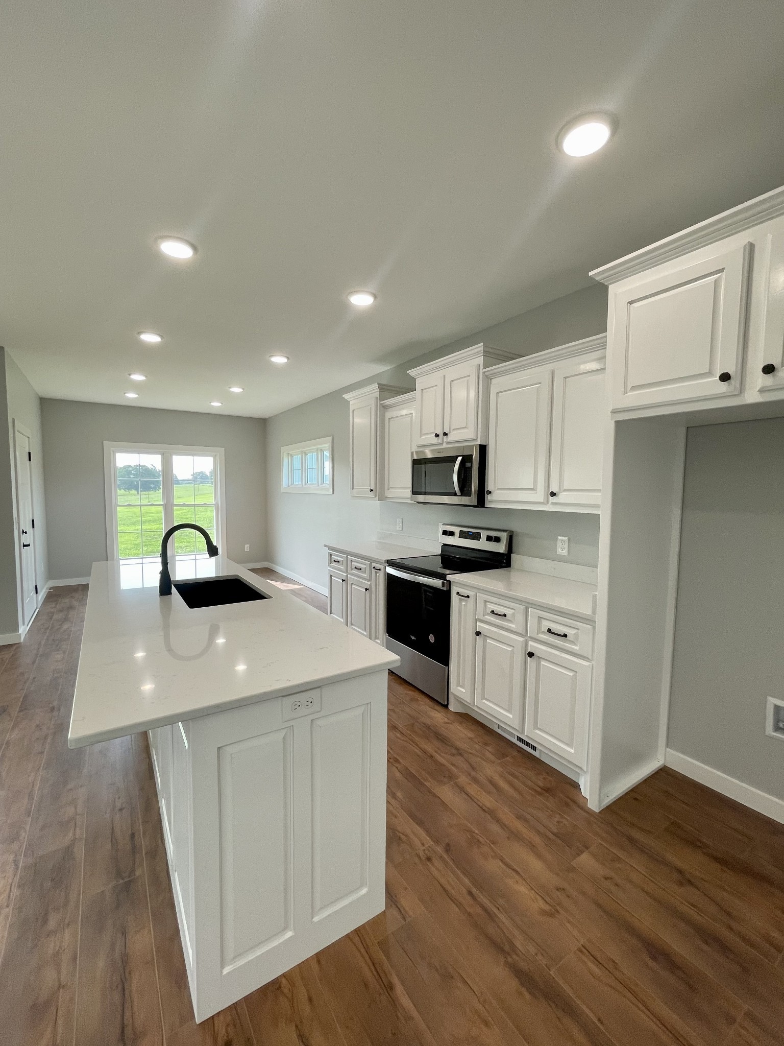 1448 Fall River Road Lawrenceburg, TN 38464 - Photo 5 of 30 a kitchen with kitchen island granite countertop a sink a stove and cabinets