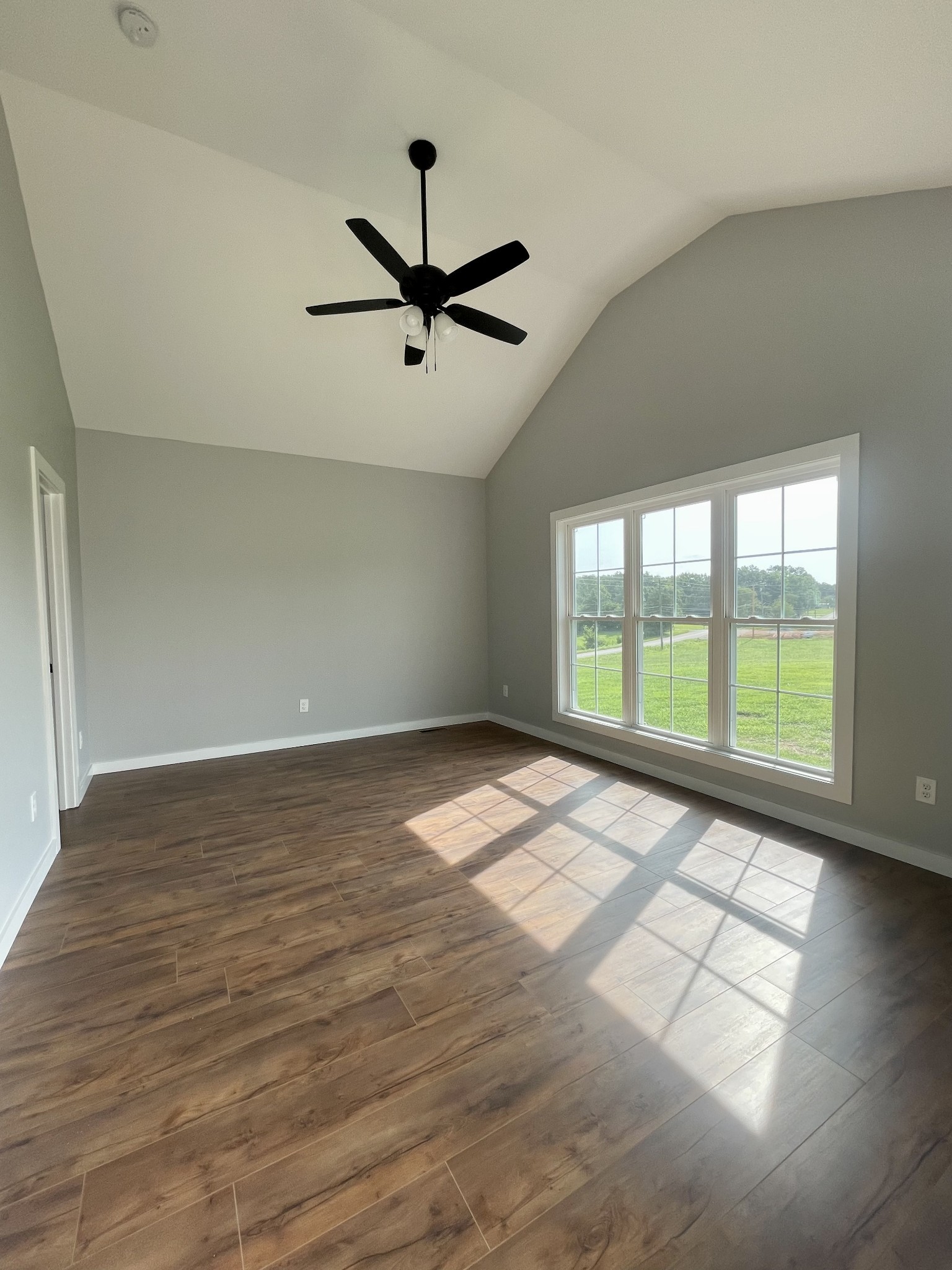 1448 Fall River Road Lawrenceburg, TN 38464 - Photo 8 of 30 an empty room with wooden floor and windows