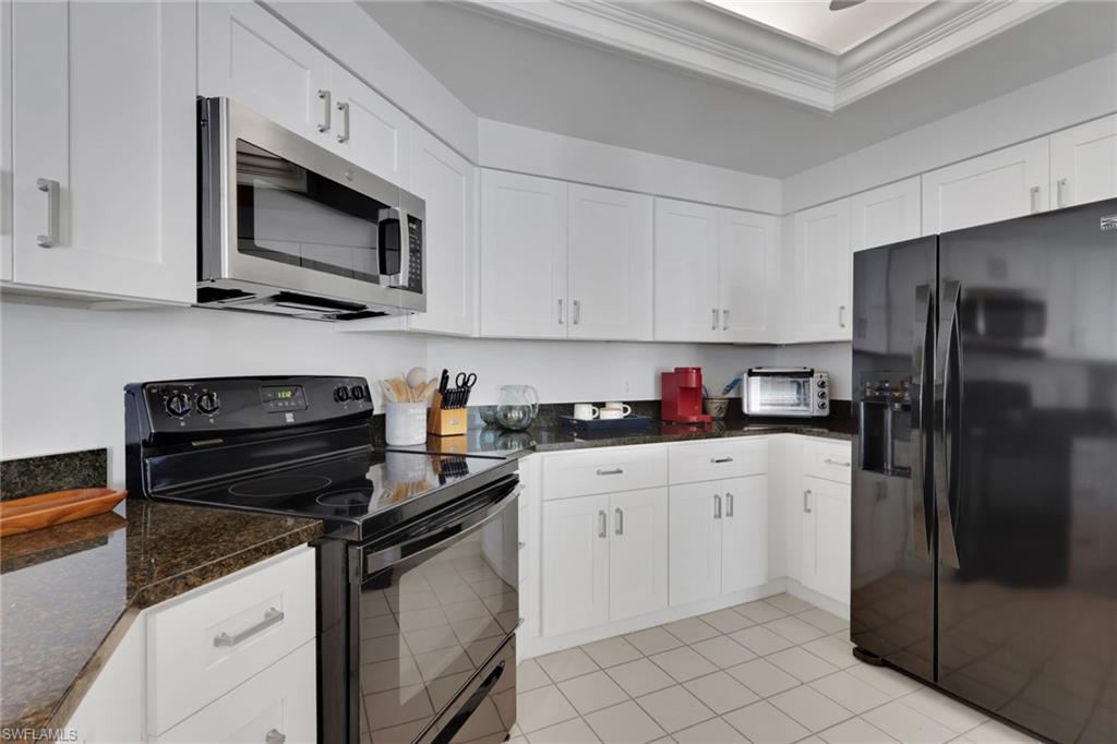 6260 Bellerive Avenue, Unit 4 Naples, FL 34119 - Photo 10 of 27 a kitchen with stainless steel appliances granite countertop a refrigerator stove and sink