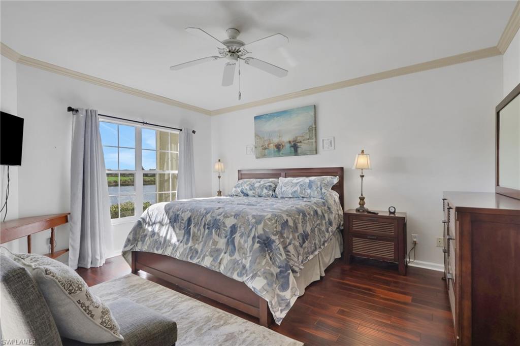 6260 Bellerive Avenue, Unit 4 Naples, FL 34119 - Photo 12 of 27 a bedroom with a large bed and a tv