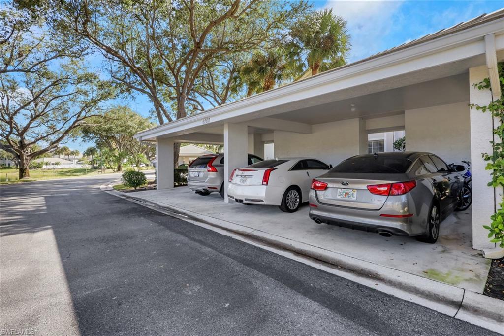 6260 Bellerive Avenue, Unit 4 Naples, FL 34119 - Photo 2 of 27 a view of a cars park in front of a house