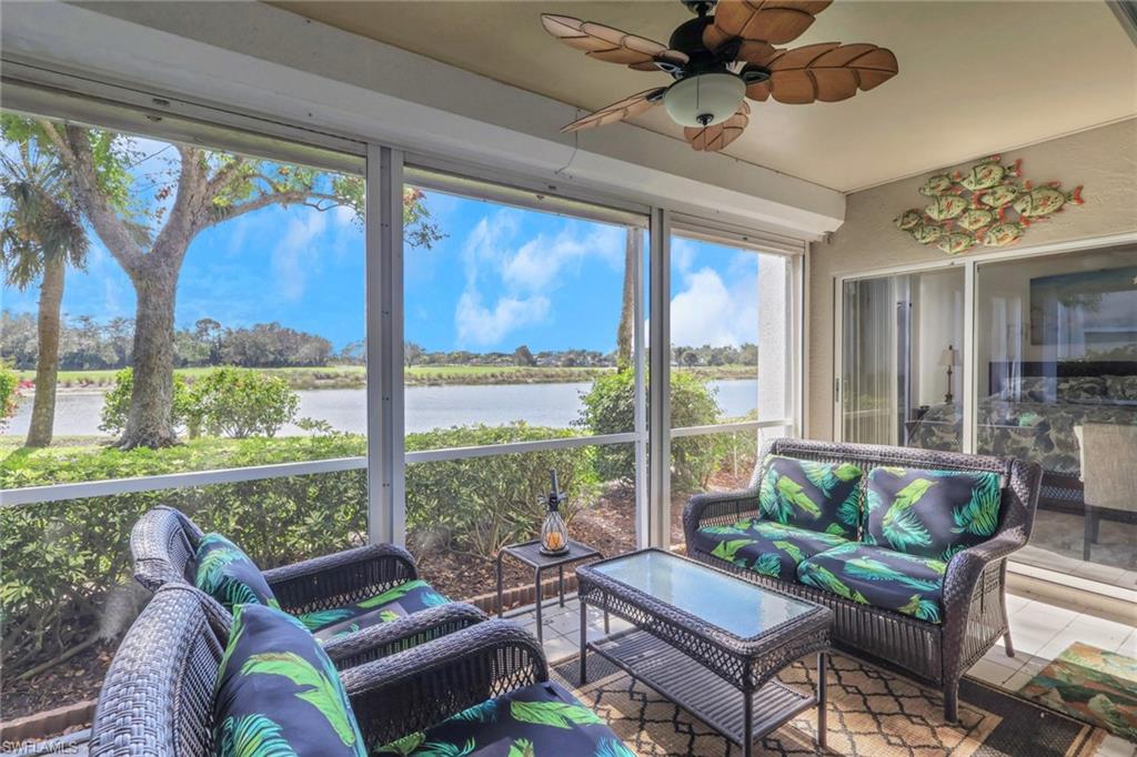 6260 Bellerive Avenue, Unit 4 Naples, FL 34119 - Photo 22 of 27 a living room with furniture and a large window