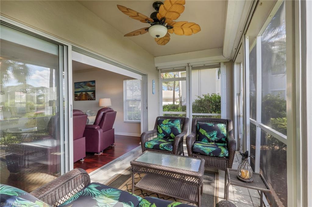 6260 Bellerive Avenue, Unit 4 Naples, FL 34119 - Photo 23 of 27 a living room with patio furniture and a potted plant