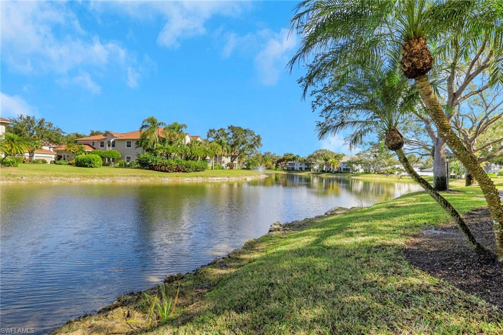 6260 Bellerive Avenue, Unit 4 Naples, FL 34119 - Photo 26 of 27 a view of a lake with houses in the back