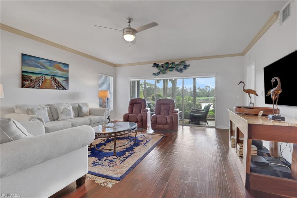 6260 Bellerive Avenue, Unit 4 Naples, FL 34119 - Photo 5 of 27 a living room with furniture and a large window