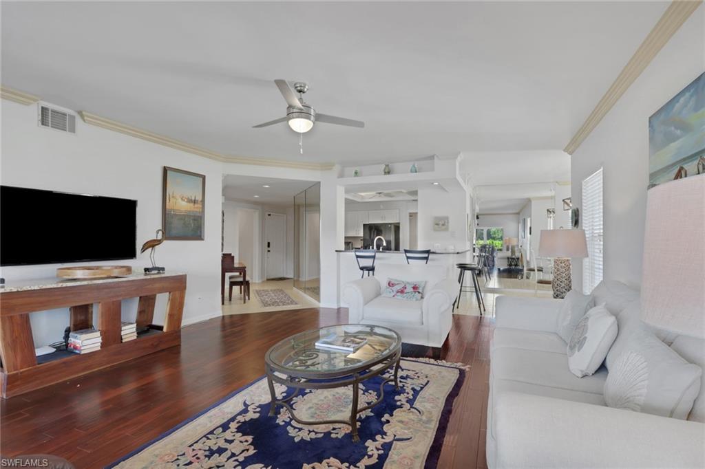 6260 Bellerive Avenue, Unit 4 Naples, FL 34119 - Photo 7 of 27 a living room with furniture and a flat screen tv