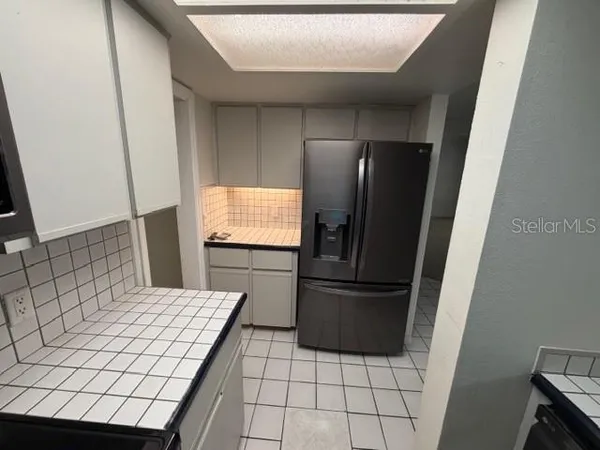 a kitchen with a refrigerator and a stove
