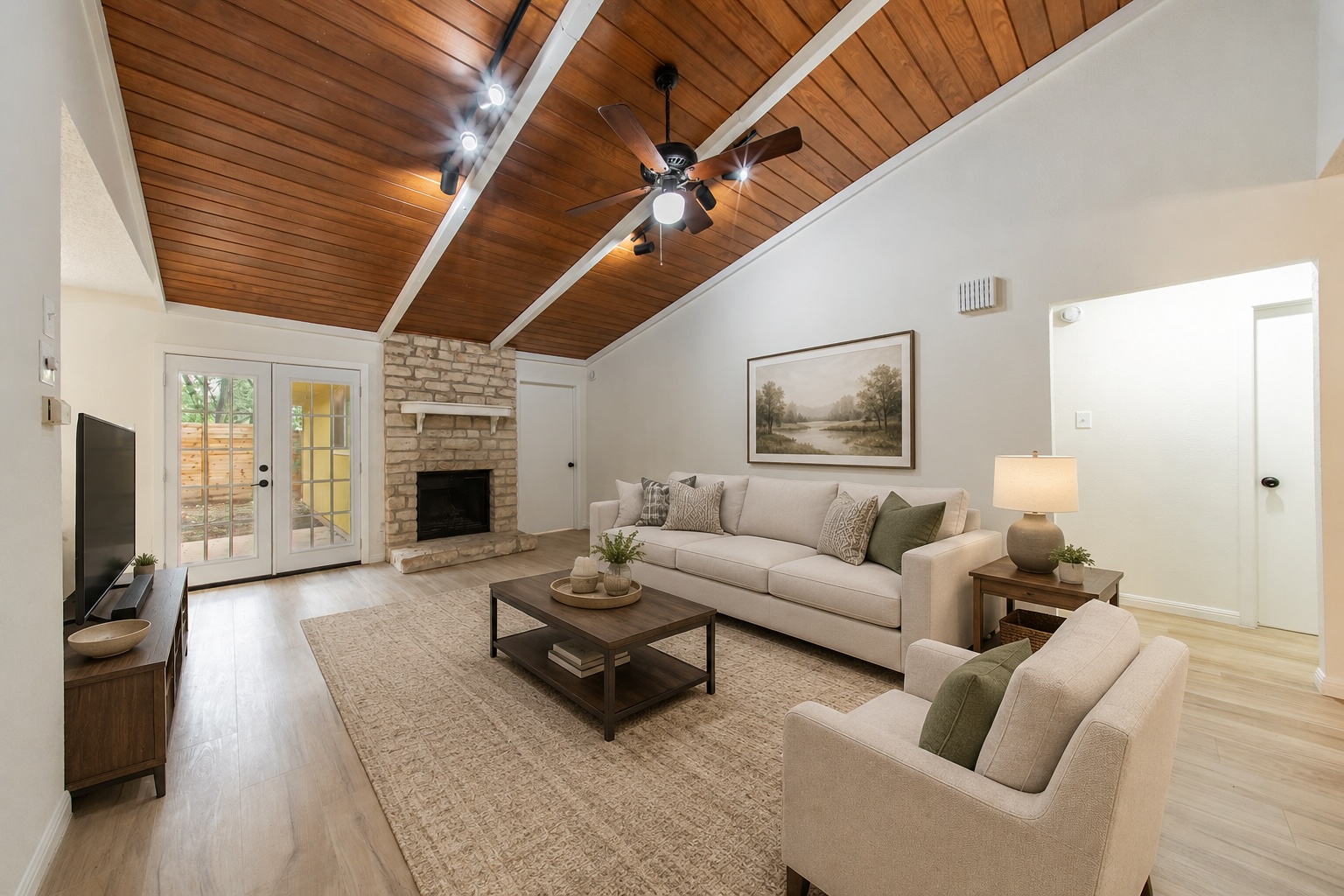 4504 Langtry Lane Austin, TX 78749 - Photo 5 of 24 A stone fireplace with a rustic mantel anchors this warm living area, brightened by French doors.