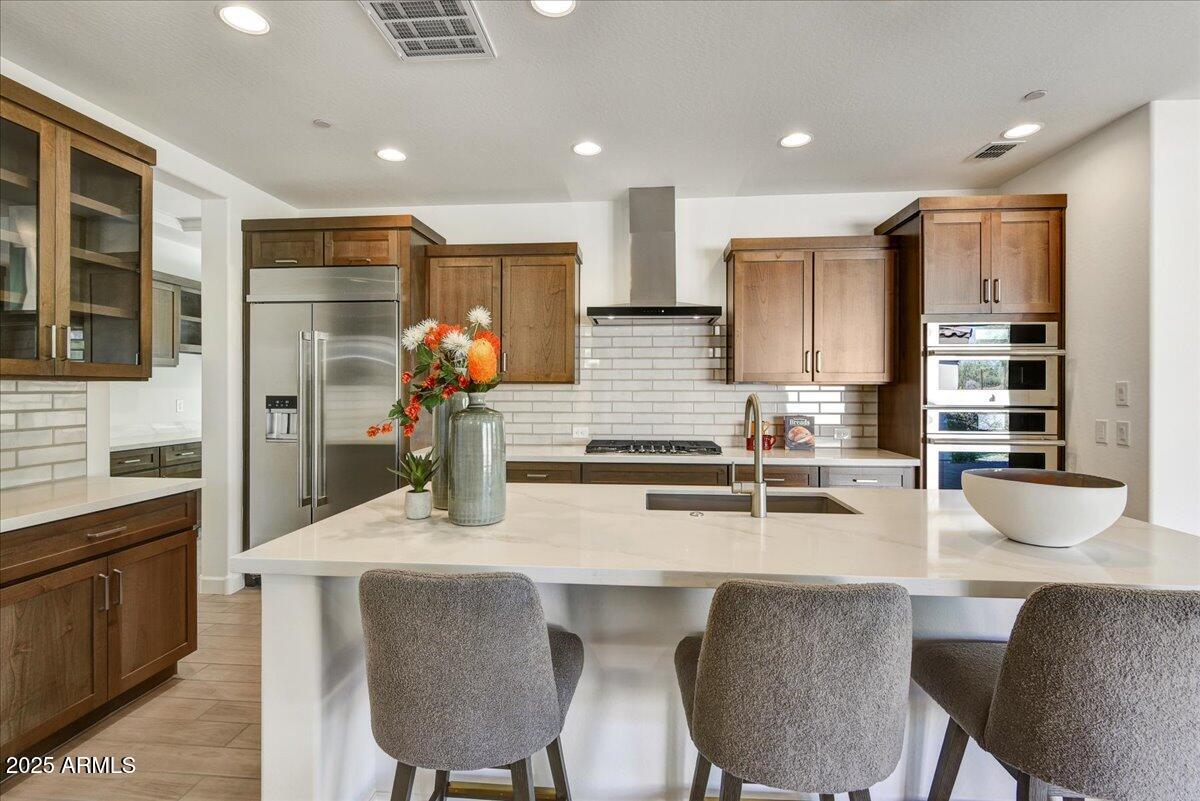 29008 North Juventino Way Rio Verde, AZ 85263 - Photo 12 of 50 a kitchen with stainless steel appliances granite countertop a table chairs sink refrigerator and microwave