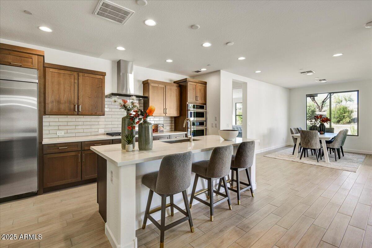 29008 North Juventino Way Rio Verde, AZ 85263 - Photo 13 of 50 a kitchen with stainless steel appliances kitchen island granite countertop a table chairs sink and cabinets