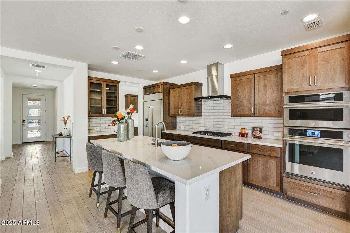 29008 North Juventino Way Rio Verde, AZ 85263 - Photo 14 of 50 a kitchen with a stove a refrigerator and a dining table