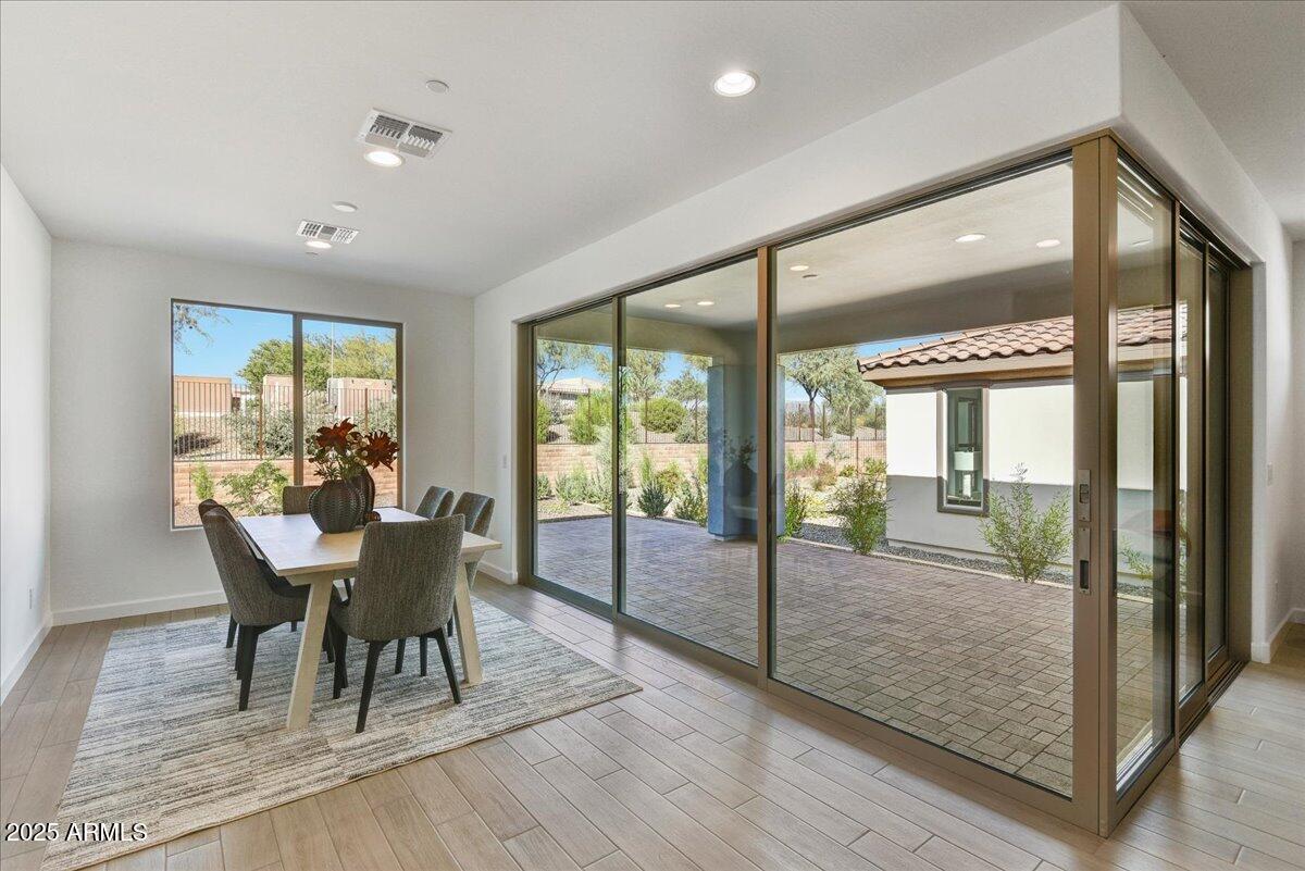 29008 North Juventino Way Rio Verde, AZ 85263 - Photo 20 of 50 a dining room with furniture a chandelier and wooden floor