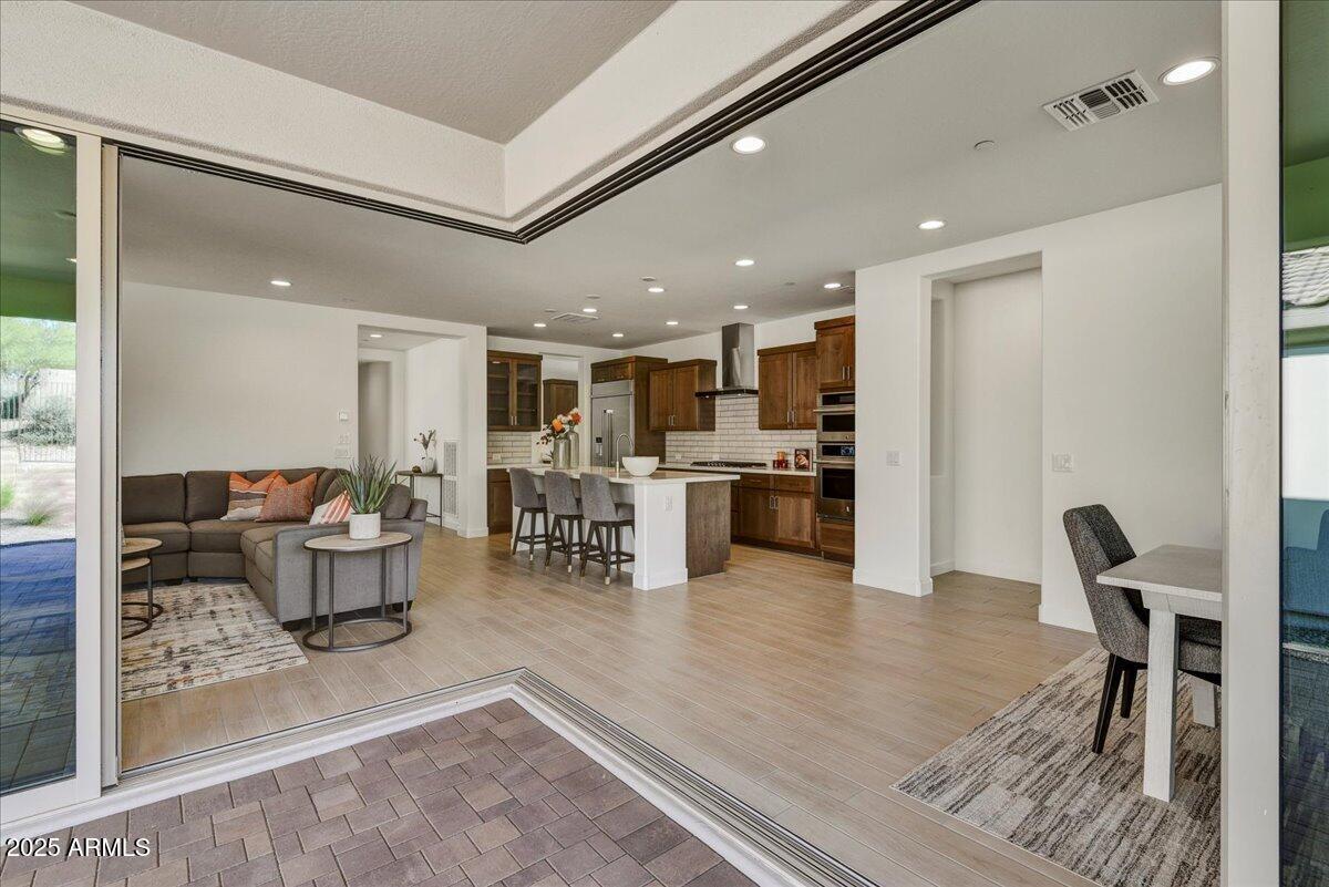 29008 North Juventino Way Rio Verde, AZ 85263 - Photo 9 of 50 a living room with furniture and kitchen view with wooden floor