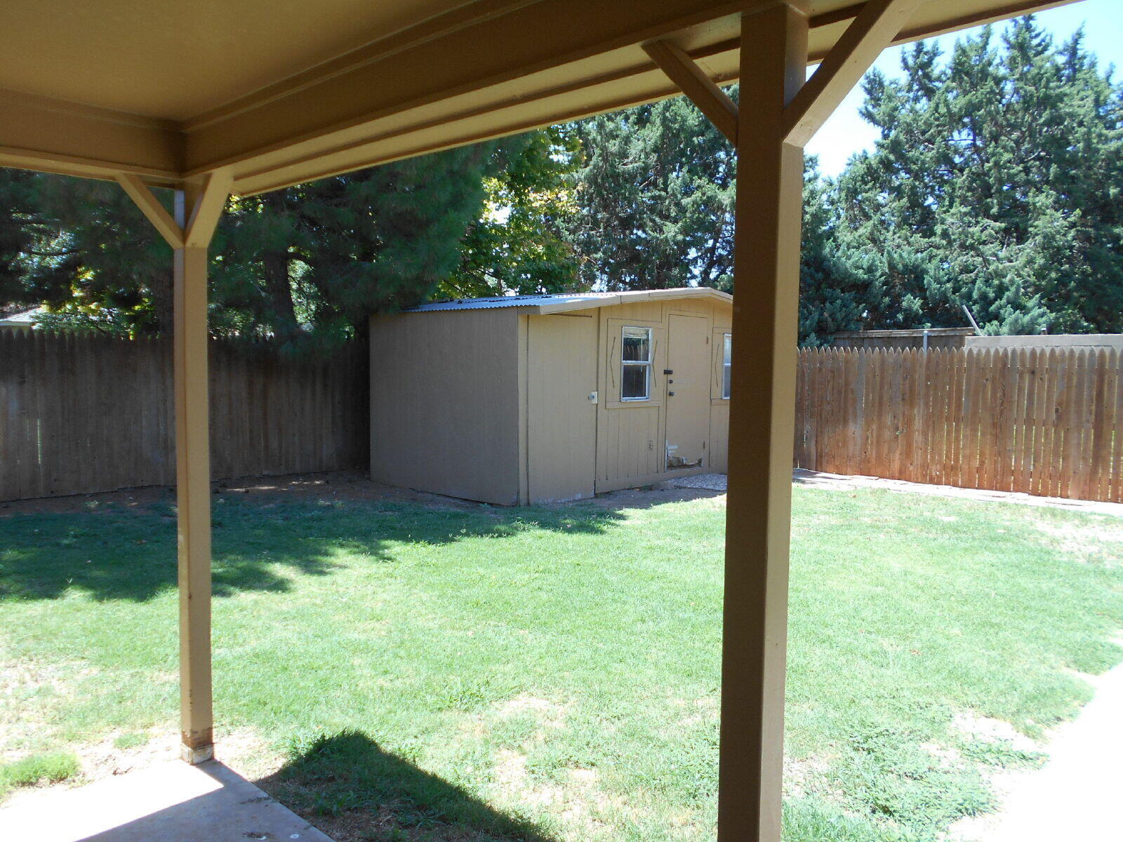 4431 77th Street Lubbock, TX 79424 - Photo 17 of 19 a backyard of a house with a yard and a fountain