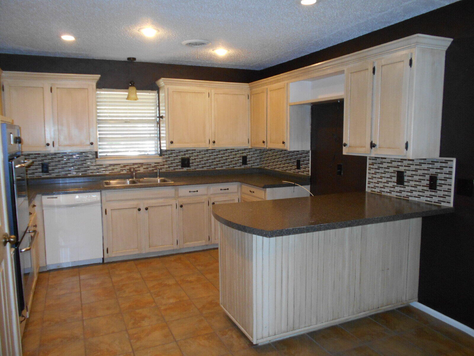 4431 77th Street Lubbock, TX 79424 - Photo 3 of 19 a kitchen with stainless steel appliances granite countertop a sink a stove and a refrigerator