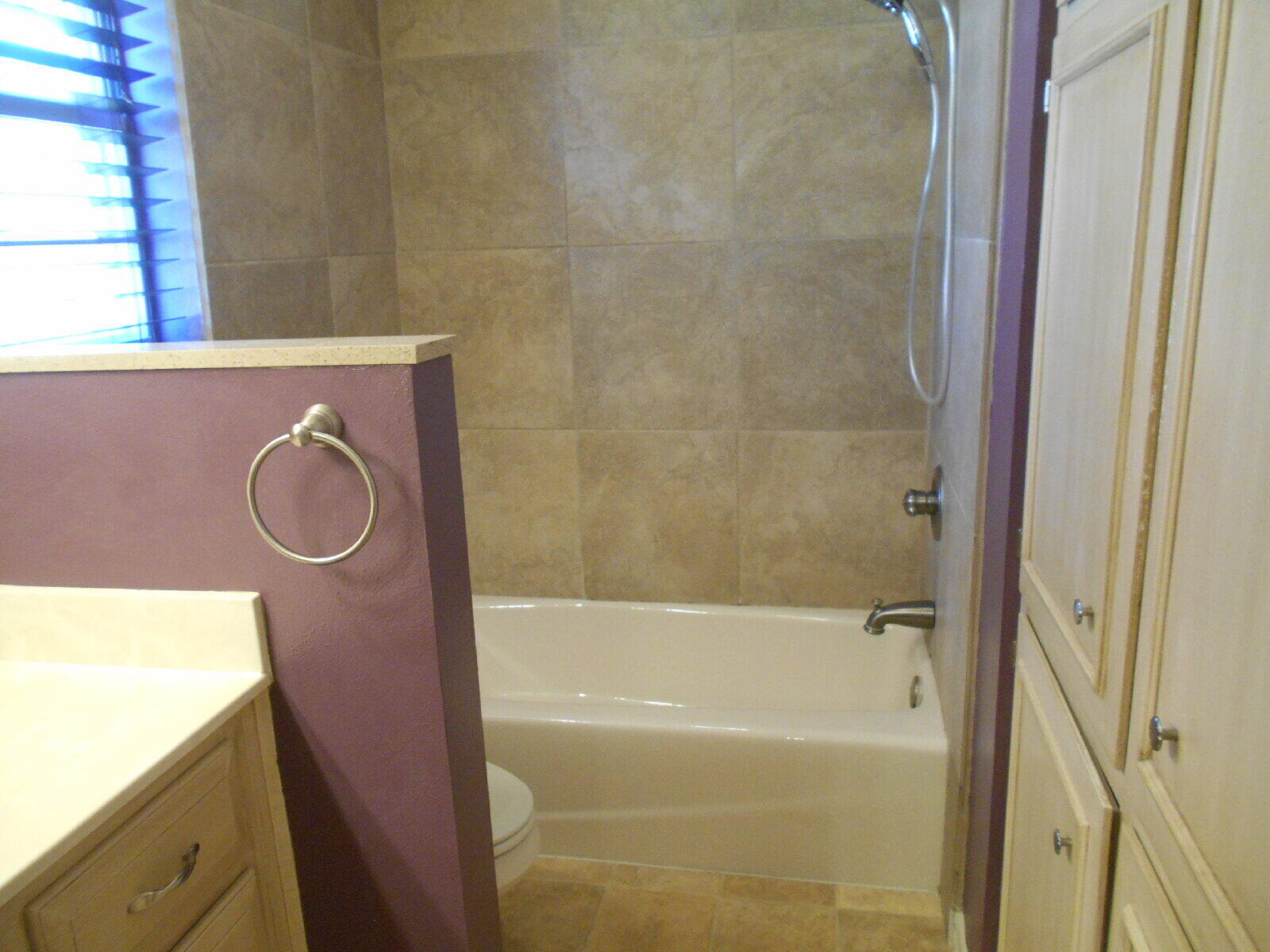 4431 77th Street Lubbock, TX 79424 - Photo 10 of 19 a bathroom with a granite countertop sink toilet and bathtub